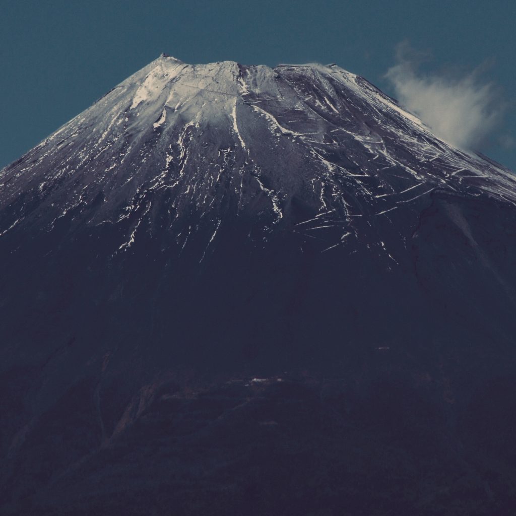 snowy Mount Fuji Summit closeup photographed in November showing the tracks that lead to the summit covered in snow